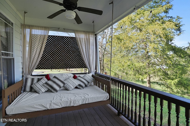 wooden terrace with a ceiling fan