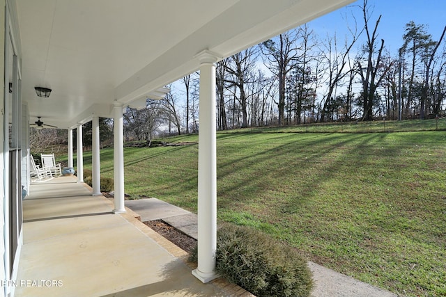 view of yard with covered porch and a ceiling fan