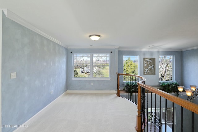 corridor with carpet, baseboards, crown molding, and an upstairs landing