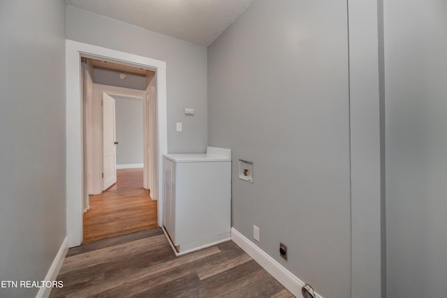 washroom featuring a textured ceiling, hookup for a washing machine, dark hardwood / wood-style floors, and hookup for an electric dryer