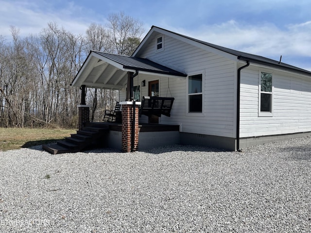 view of front of house with crawl space, covered porch, metal roof, and a standing seam roof