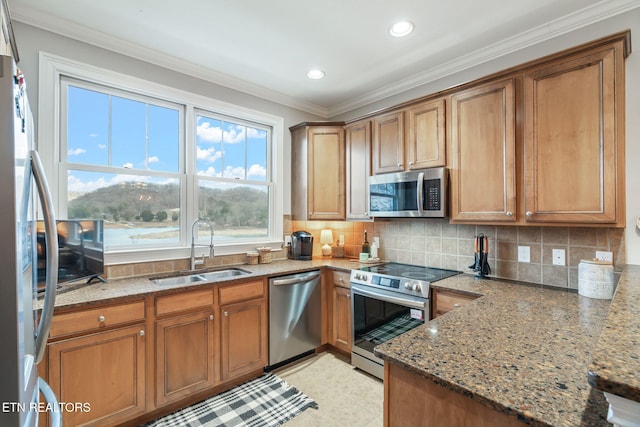 kitchen with light stone countertops, sink, crown molding, and appliances with stainless steel finishes