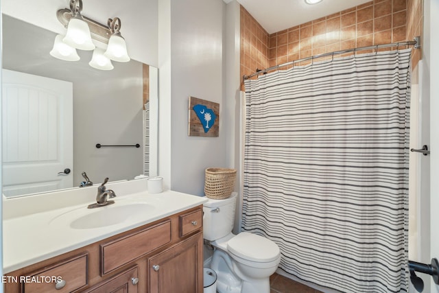 bathroom featuring toilet, vanity, and a shower with shower curtain