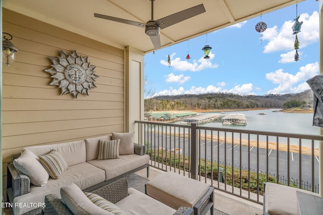 balcony with a water view and ceiling fan