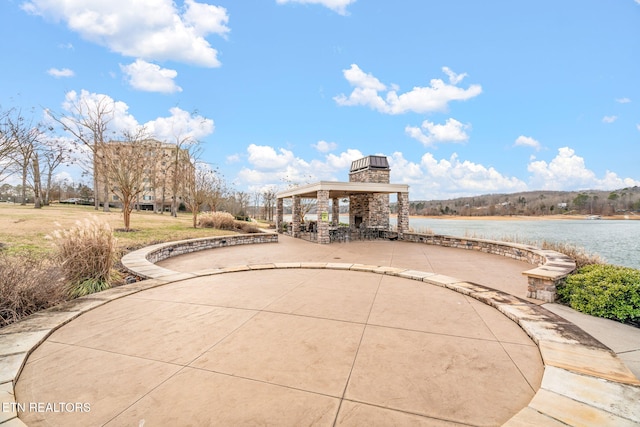 view of patio with a gazebo and a water view