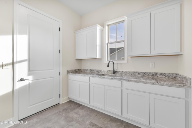 360 Poppy Pl, Lenoir City, TN 37772 - kitchen with white cabinetry, a sink, and light stone counters