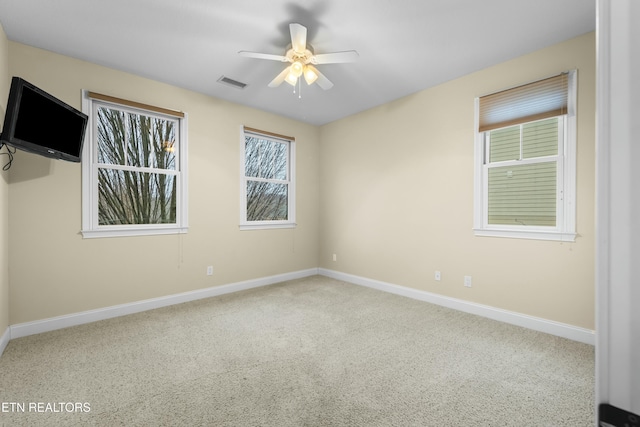 carpeted empty room featuring ceiling fan