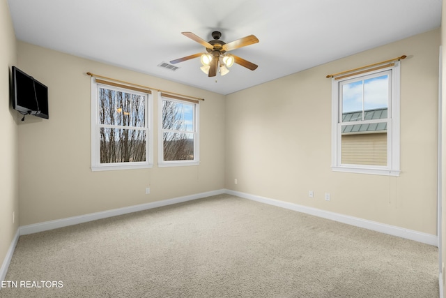 carpeted empty room featuring ceiling fan