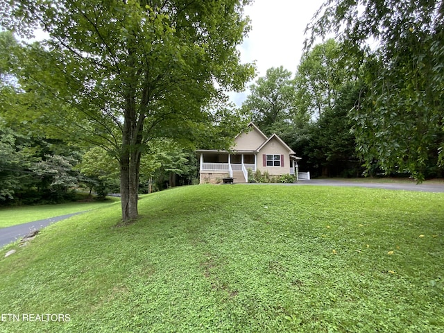 view of front of home with a front lawn and a porch