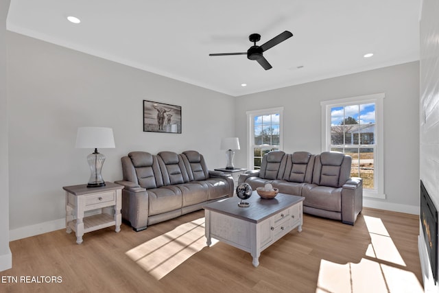 living room featuring light hardwood / wood-style floors and ceiling fan