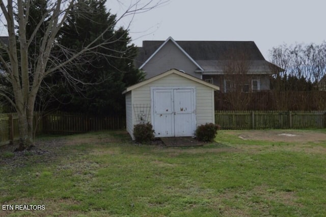 view of outdoor structure featuring a lawn