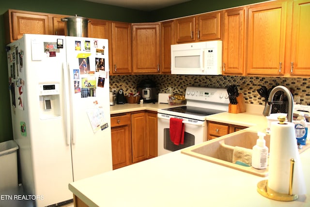 kitchen featuring white appliances and backsplash