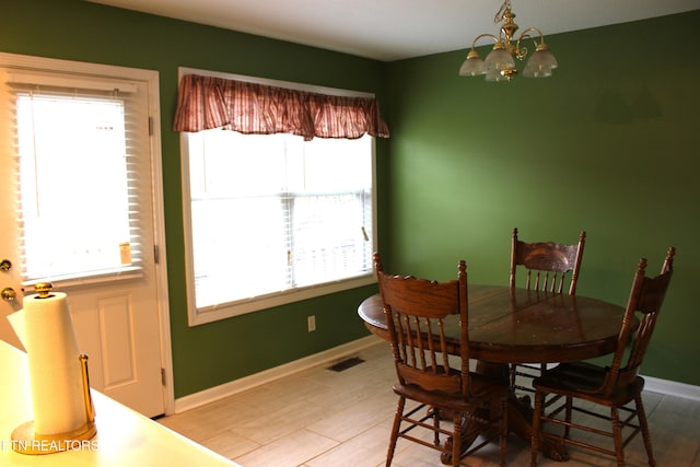 dining area with an inviting chandelier