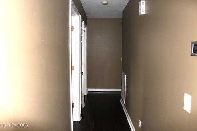 hall featuring a textured ceiling