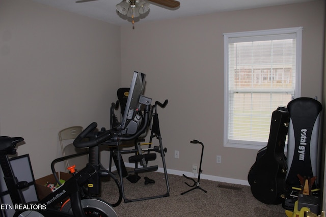 workout room featuring ceiling fan, carpet floors, and a wealth of natural light