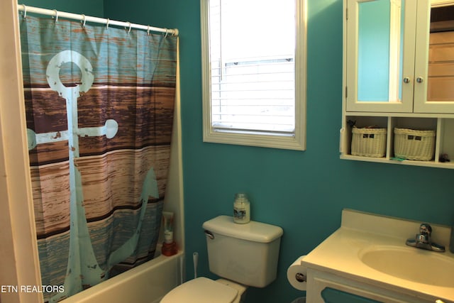 full bathroom with vanity, shower / tub combo, and toilet