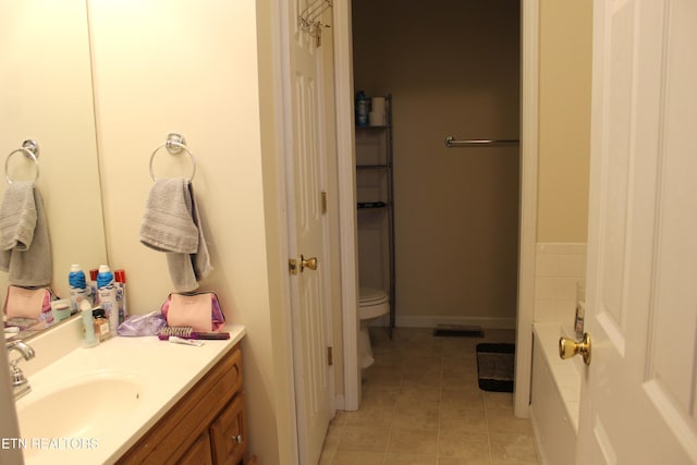 bathroom featuring tile patterned floors, vanity, and toilet