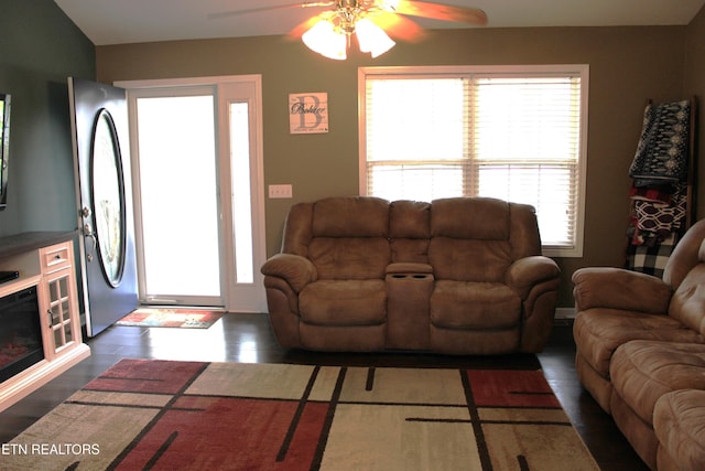 living room featuring a wealth of natural light, ceiling fan, and dark hardwood / wood-style floors