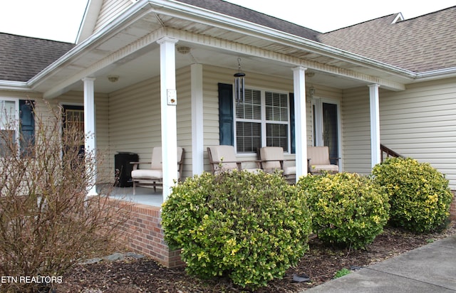 view of exterior entry with covered porch