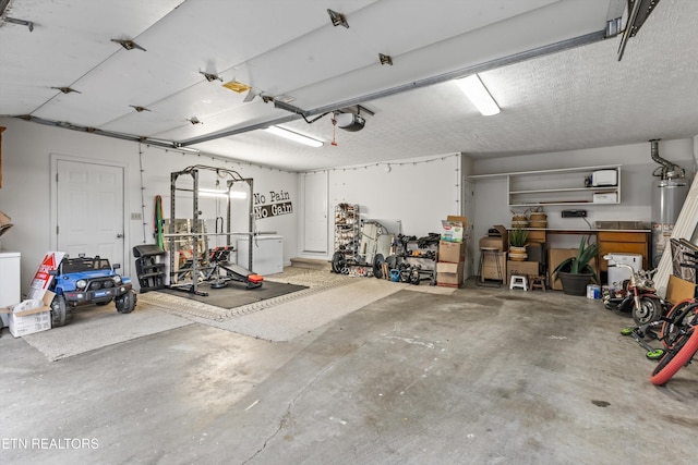 garage featuring gas water heater and a garage door opener