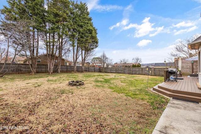 view of yard with an outdoor fire pit and a deck