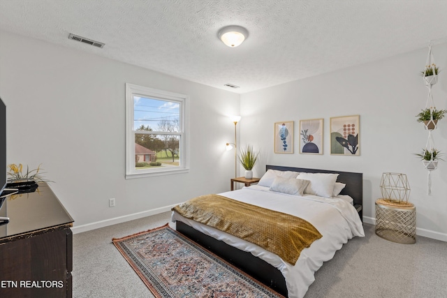 carpeted bedroom with a textured ceiling