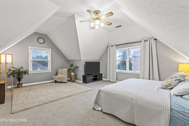 carpeted bedroom featuring multiple windows, a textured ceiling, ceiling fan, and lofted ceiling