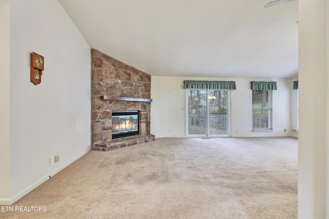 unfurnished living room featuring a fireplace, light colored carpet, and vaulted ceiling