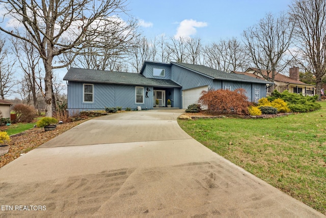 view of front of home with a garage and a front yard