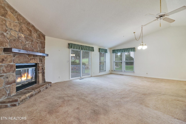 unfurnished living room featuring a fireplace, carpet, ceiling fan with notable chandelier, and vaulted ceiling