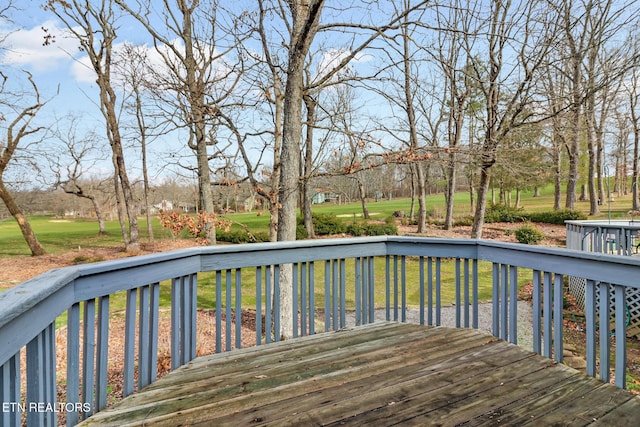 wooden terrace with a lawn