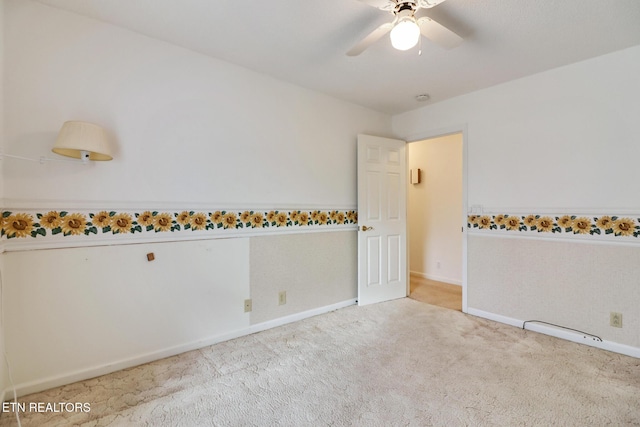 unfurnished room featuring light carpet and ceiling fan