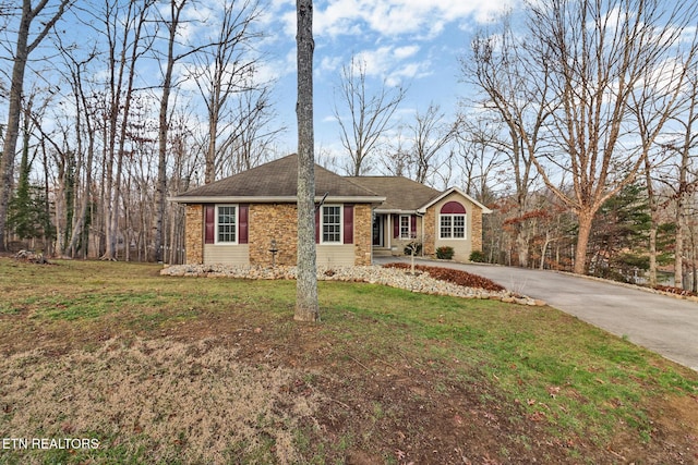 ranch-style home with a front lawn