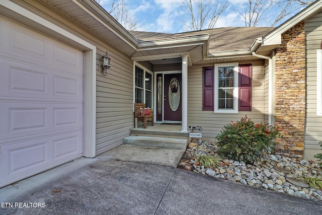 view of exterior entry with a garage