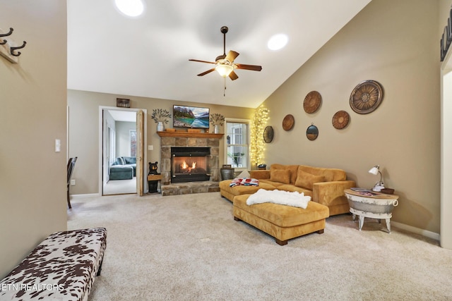 living room with a stone fireplace, ceiling fan, high vaulted ceiling, and light colored carpet