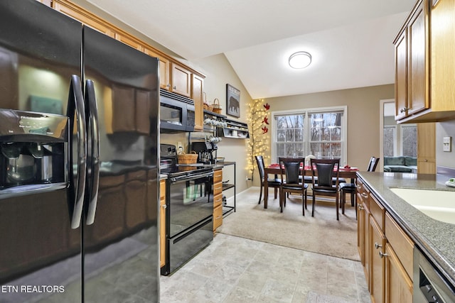 kitchen featuring black appliances, light colored carpet, sink, and vaulted ceiling