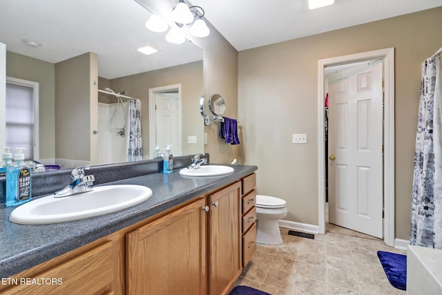 bathroom with a shower with shower curtain, vanity, toilet, and ceiling fan