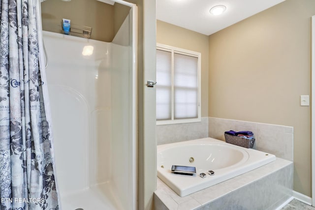 bathroom with separate shower and tub