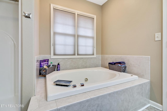 bathroom featuring a relaxing tiled tub