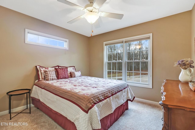 carpeted bedroom with multiple windows and ceiling fan