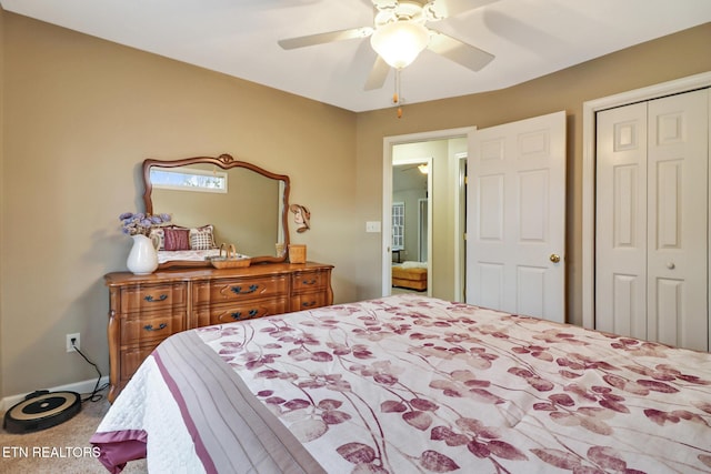 carpeted bedroom with ceiling fan and a closet