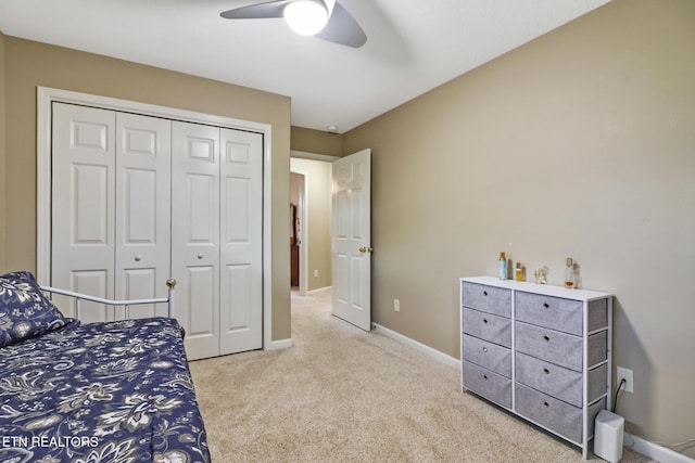 carpeted bedroom with a closet and ceiling fan