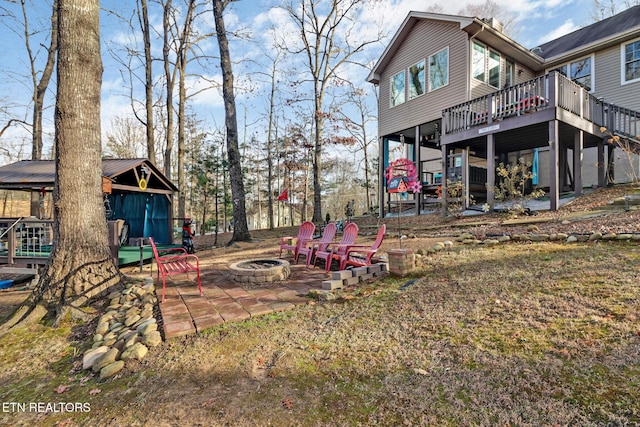 view of yard with a patio, a fire pit, and a deck