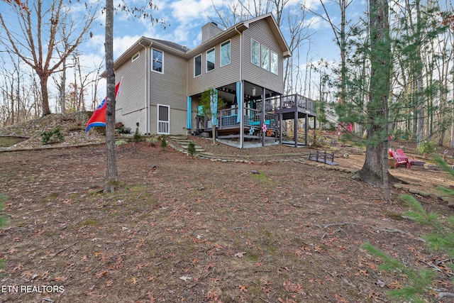 rear view of property with a wooden deck