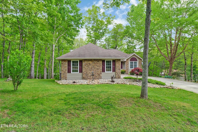 113 Burrough Ln, Fairfield Glade, TN 38558 - view of front of property with stone siding, a front lawn, and driveway