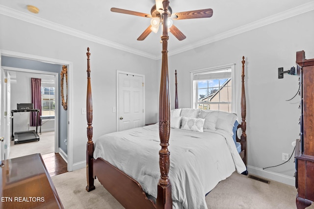 bedroom featuring light carpet, multiple windows, ceiling fan, and crown molding