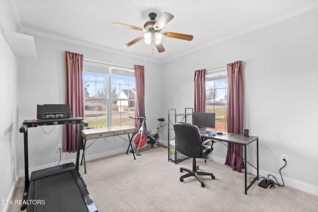 home office featuring light carpet, crown molding, and a healthy amount of sunlight