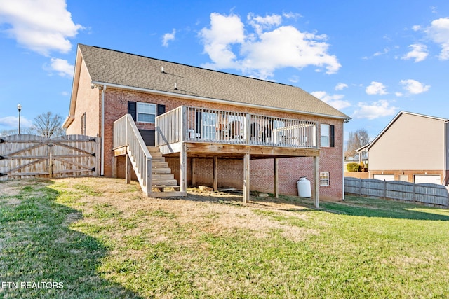 rear view of house featuring a yard and a wooden deck