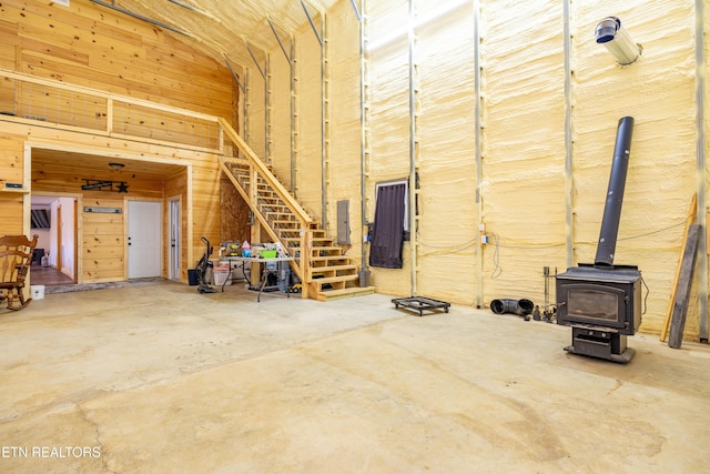 garage with a wood stove and electric panel