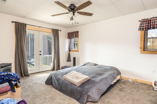 carpeted bedroom featuring access to outside, a paneled ceiling, ceiling fan, and french doors